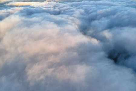 Aerial view from high altitude of earth covered with puffy rainy clouds forming before rainstorm