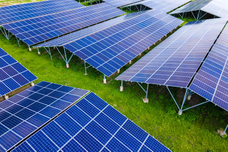 Aerial view of large sustainable electrical power plant with rows of solar photovoltaic panels for producing clean ecological electric energy. Renewable electricity with zero emission conceptの写真素材
