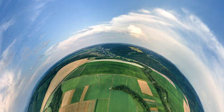 Aerial view from high altitude of little planet earth with green and yellow cultivated agricultural...
