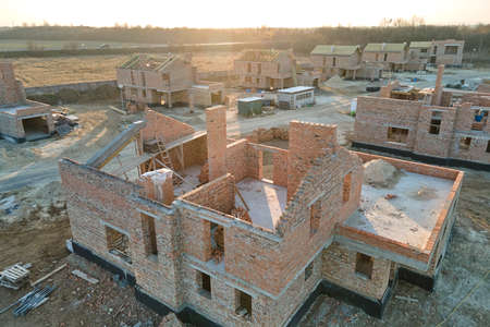 Industrial building site in rural area with residential houses under construction for future sale or...