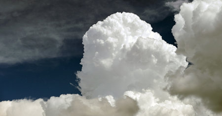 Bright landscape of white puffy cumulus clouds on blue clear skyの写真素材