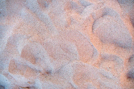 Flat view of clean yellow sand surface covering seaside beach. Sandy texture