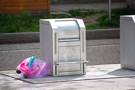 Stainless steel garbage cans for separate disposal of recycle trash on city streetの写真素材