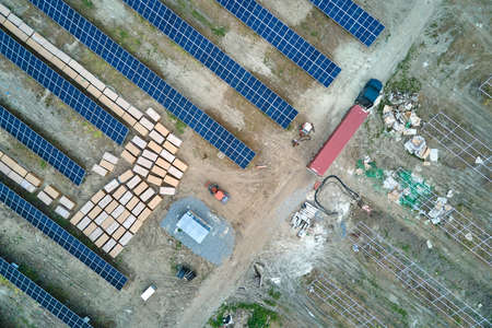 Aerial view of electrical power plant under construction with truck delivering assembly parts for...