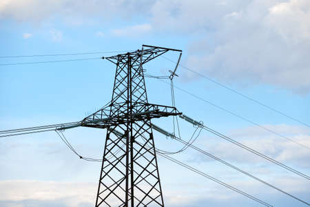 Steel pillar with high voltage electric power lines delivering electrical energy through cable wires...