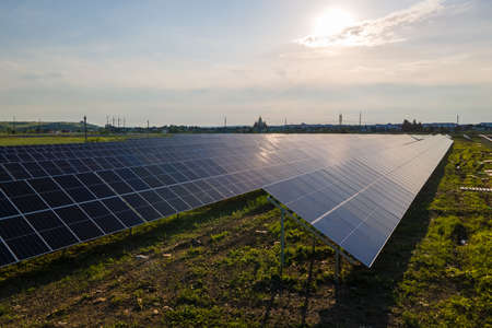 Aerial view of big sustainable electric power plant with many rows of solar photovoltaic panels for...