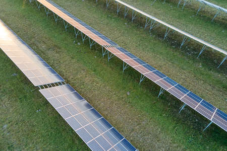 Aerial view of large sustainable electrical power plant with rows of solar photovoltaic panels for...
