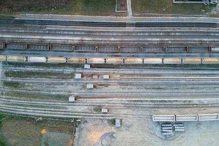 Aerial view of cargo train loaded with crushed sandstone materials at mine factory. Railway transportation of open pit mining oreの写真素材