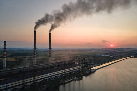 Aerial view of coal power plant high pipes with black smokestack polluting atmosphere. Electricity...