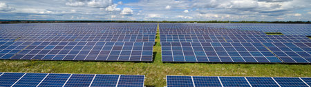 Aerial view of large sustainable electrical power plant with rows of solar photovoltaic panels for producing clean electric energy. Concept of renewable electricity with zero emissionの写真素材