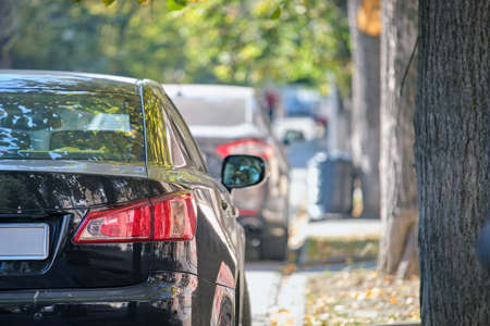 Close up of a car parked illegally against traffic rules on pedestrian city street sideの写真素材