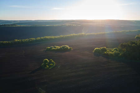 Aerial view of plowed agricultural fields with cultivated fertile soil prepared for planting crops...