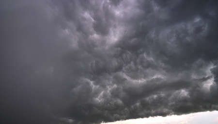 Landscape of dark ominous clouds like volcano eruption on stormy sky during heavy thunderstorm