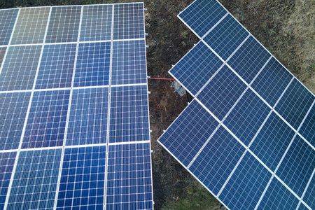 Solar photovoltaic panels mounted on stand-alone frame on backyard ground for generating of clean...
