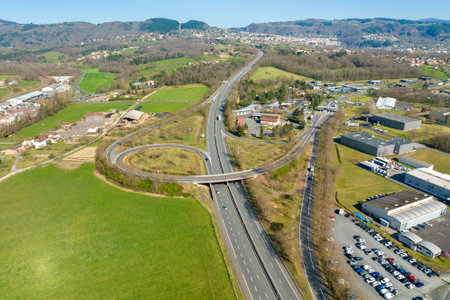 Aerial view of highway road intersection with fast moving heavy traffic. Intercity transportation with many cars and trucksの写真素材