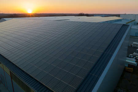 Blue photovoltaic solar panels mounted on building roof for producing clean ecological electricity...