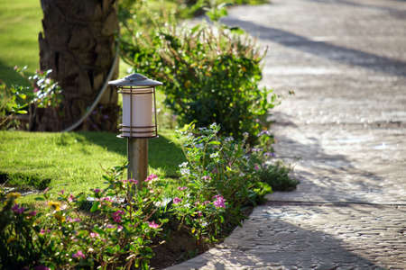 Outdoor lamp on yard lawn for garden lighting in summer parkの写真素材