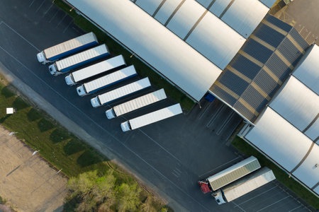 Aerial view of goods warehouses and logistics center in industrial city zone from above