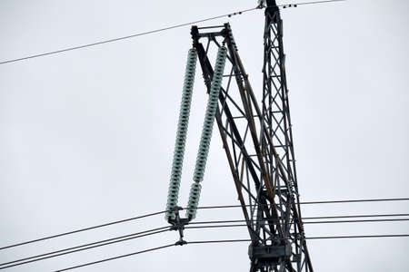 High voltage tower with electric power lines divided by safe guard bushing transfening safely...