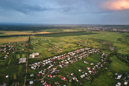 Aerial view of residential houses in suburban rural area at sunsetの写真素材