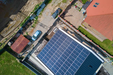 Residential house with rooftop covered with solar photovoltaic panels for producing of clean...