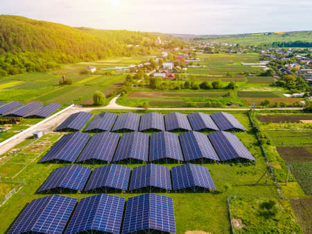 Aerial view of large sustainable electrical power plant with rows of solar photovoltaic panels for producing clean ecological electric energy. Renewable electricity with zero emission conceptの写真素材