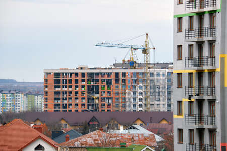 Tower cranes at high residential apartment buildings construction site. Real estate development