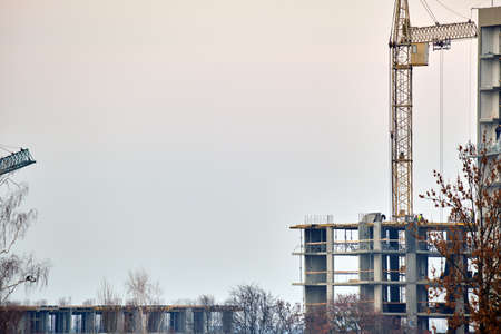 Tower cranes at high residential apartment buildings construction site. Real estate developmentの写真素材