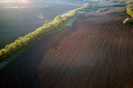 Aerial view of plowed agricultural fields with cultivated fertile soil prepared for planting crops...