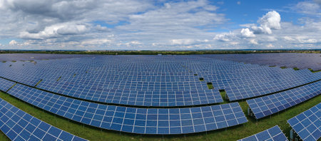 Aerial view of large sustainable electrical power plant with rows of solar photovoltaic panels for...
