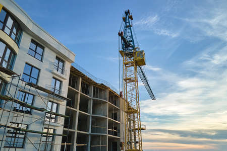 Tower cranes at high residential apartment buildings construction site. Real estate developmentの写真素材