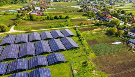 Aerial view of large sustainable electrical power plant with rows of solar photovoltaic panels for...
