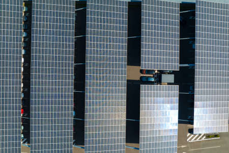 Aerial view of solar panels installed over parking lot with parked cars for effective generation of clean energyの写真素材
