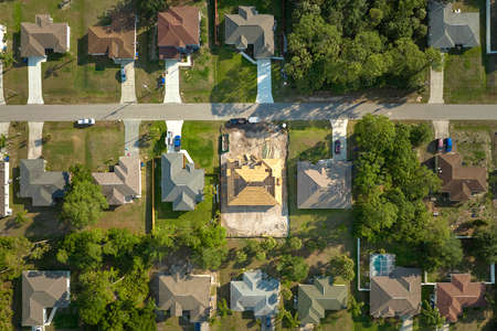 Aerial view of suburban private house wit wooden roof frame under construction in Florida quiet rural areaの写真素材