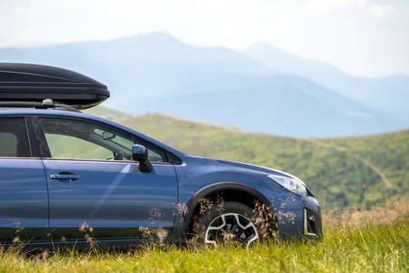 Blue off road car on mountain trail. Traveling by auto, adventure in wildlife, expedition or extreme...