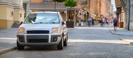 Close up of a car parked on city street sideの写真素材