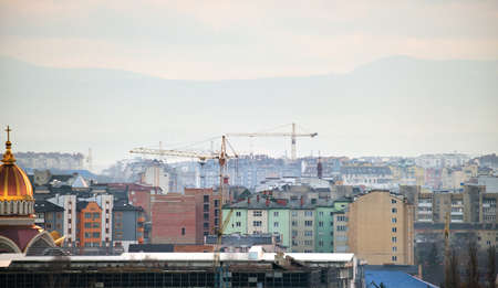 Tower cranes at high residential apartment buildings construction site. Real estate developmentの写真素材