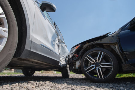 Damaged in heavy car accident vehicles after collision on city street crash site. Road safety and insurance conceptの写真素材