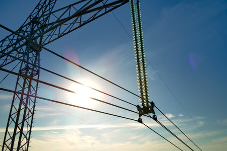 High voltage tower with electric power lines transfening electrical energy through cable wiresの写真素材