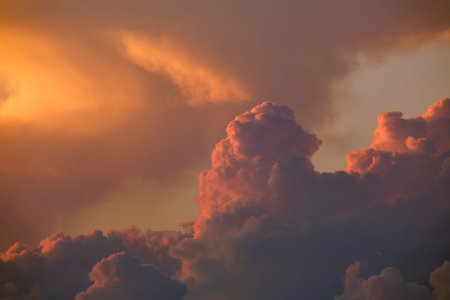 White fluffy cumulonimbus clouds forming before thunderstorm on evening sky. Changing stormy...