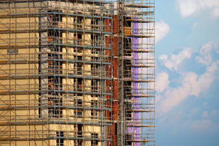 Tower cranes and frame structure of high residential apartment buildings at construction site. Real estate developmentの写真素材