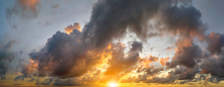 Colofrul clouds brightly illuninated by setting sun on evening sky. Changing cloudscape weather at...