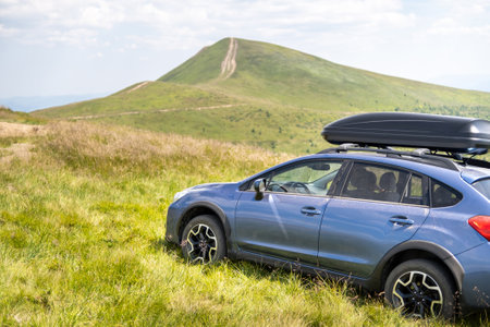 Blue off road car on mountain trail. Traveling by auto, adventure in wildlife, expedition or extreme travel on SUV automobileの写真素材