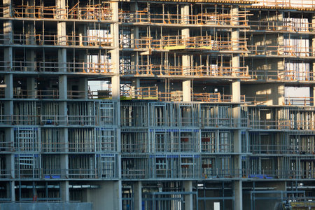Tower cranes and frame structure of high residential apartment buildings at construction site. Real...