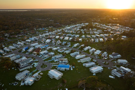 Severely damaged by hurricane Ian houses in Florida mobile home residential area. Consequences of natural disasterの写真素材