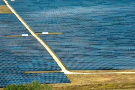 Aerial view of big sustainable electric power plant with many rows of solar photovoltaic panels for producing clean electrical energy. Renewable electricity with zero emission conceptの写真素材