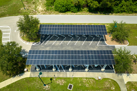 Aerial view of solar panels installed as shade roof over parking lot for parked cars for effective...