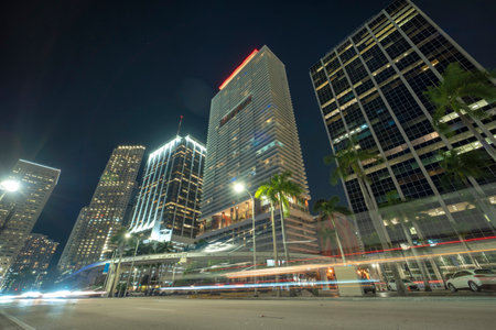 Downtown district of of Miami Brickell in Florida, USA. Brightly illuminated high skyscraper buildings and street with car trails and metrorail traffic in modern american midtownの写真素材