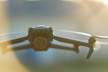Drone quadcopter with digital camera and fast rotating propellers flying taking video and pictures