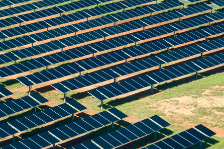 Aerial view of big sustainable electric power plant with many rows of solar photovoltaic panels for producing clean electrical energy. Renewable electricity with zero emission conceptの写真素材
